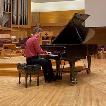 Adam playing a grand piano